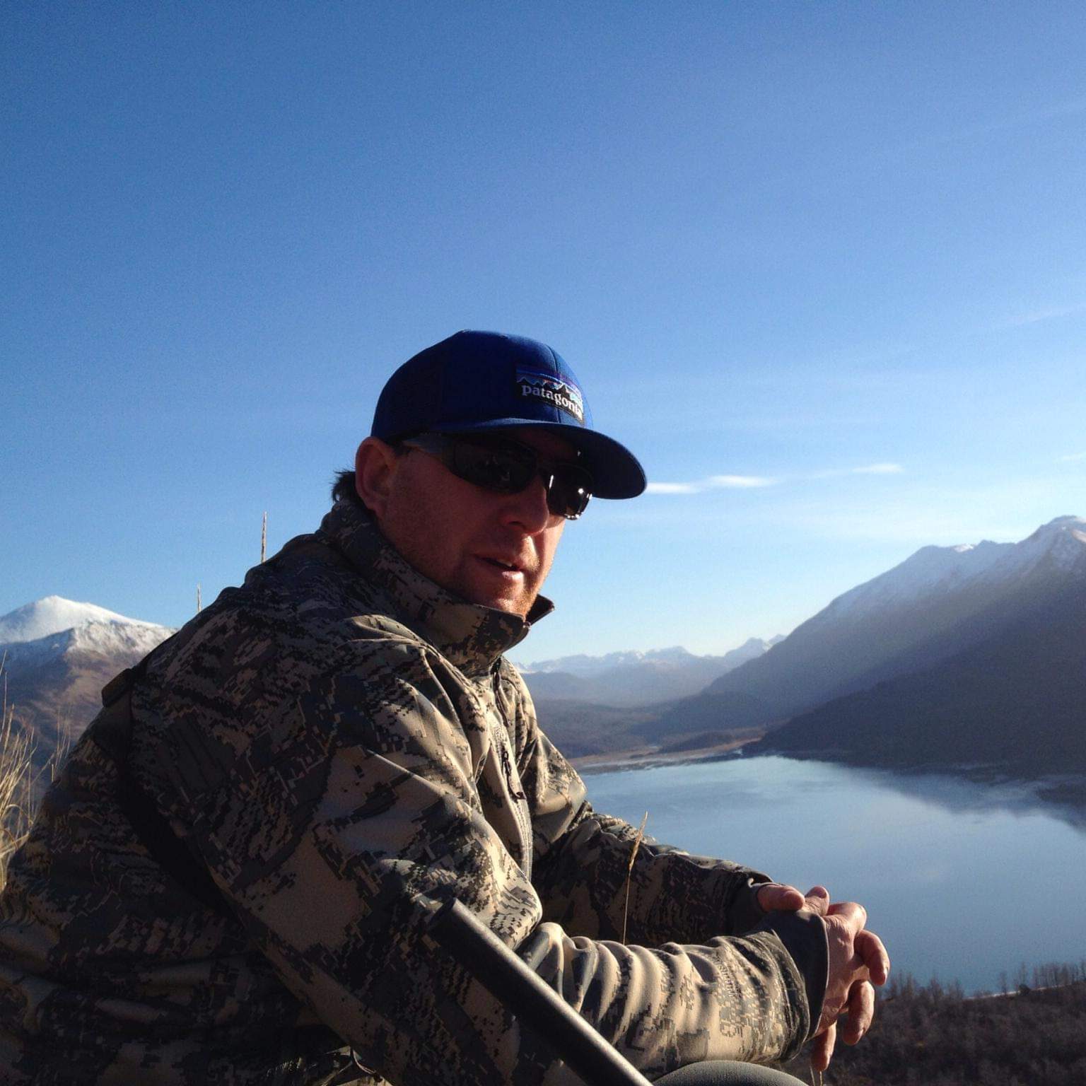 Mack Miessner in the Alaska backcountry overlooking a mountain lake