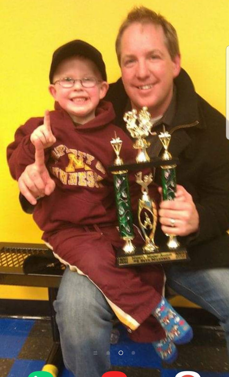 Mack Miessner celebrating a trophy win with his son